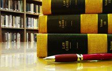 A pen is sitting on a table next to a stack of law books.
