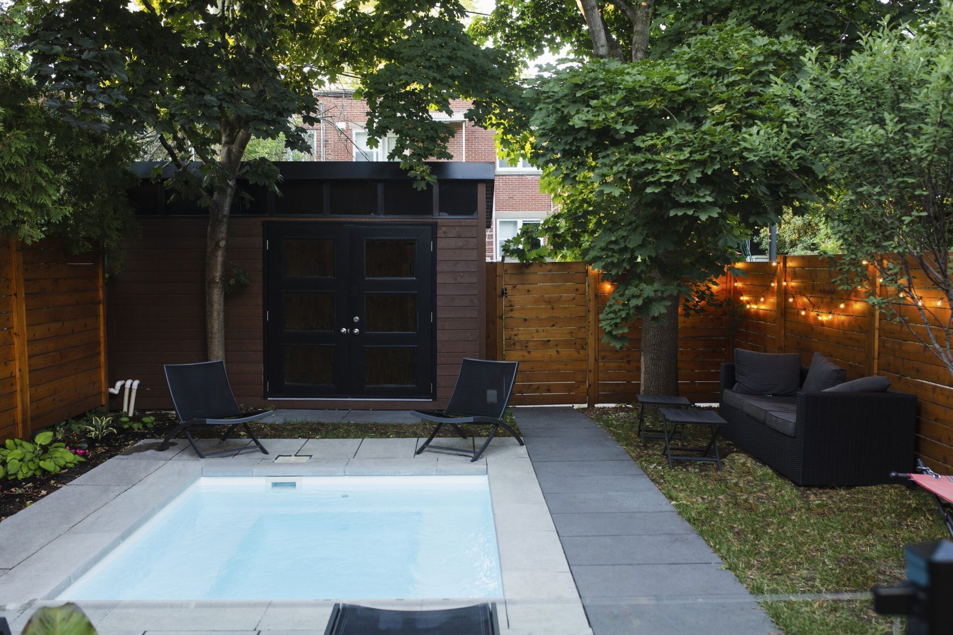 A cold plunge pool in a small backyard.