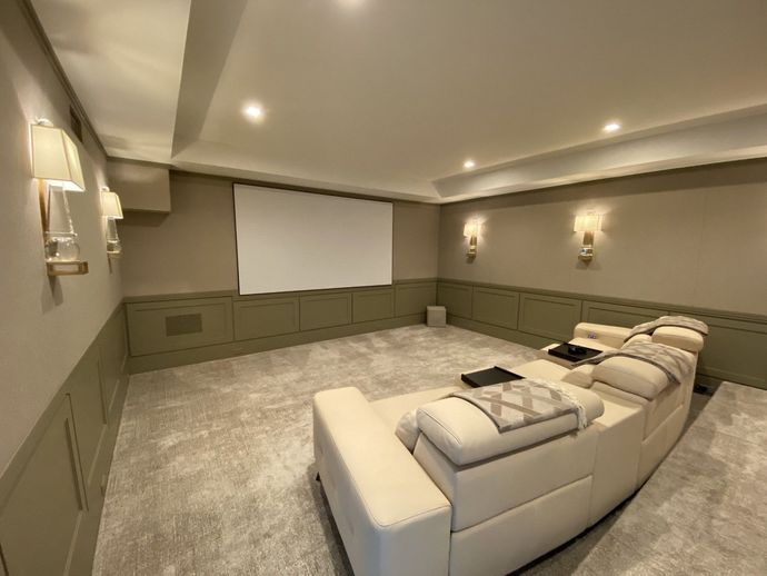 Modern entertainment center with fireplace, built-in TV, flanked by mirrored doors, white walls.