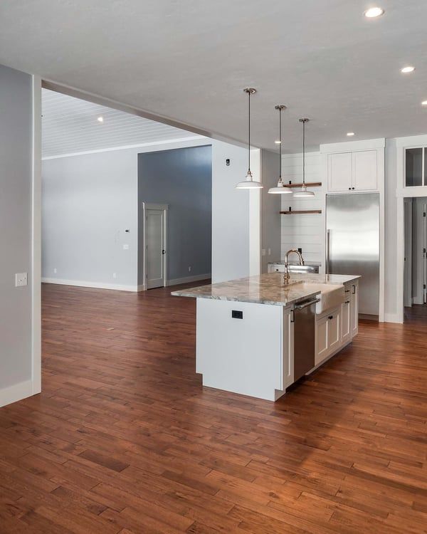 A kitchen with a large island and stainless steel appliances