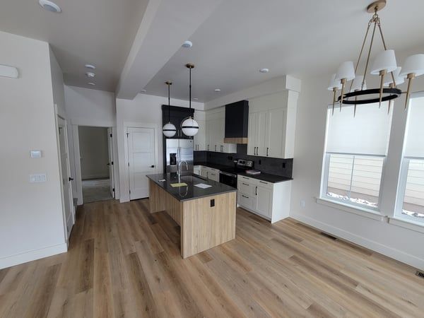 An empty kitchen with a large island in the middle