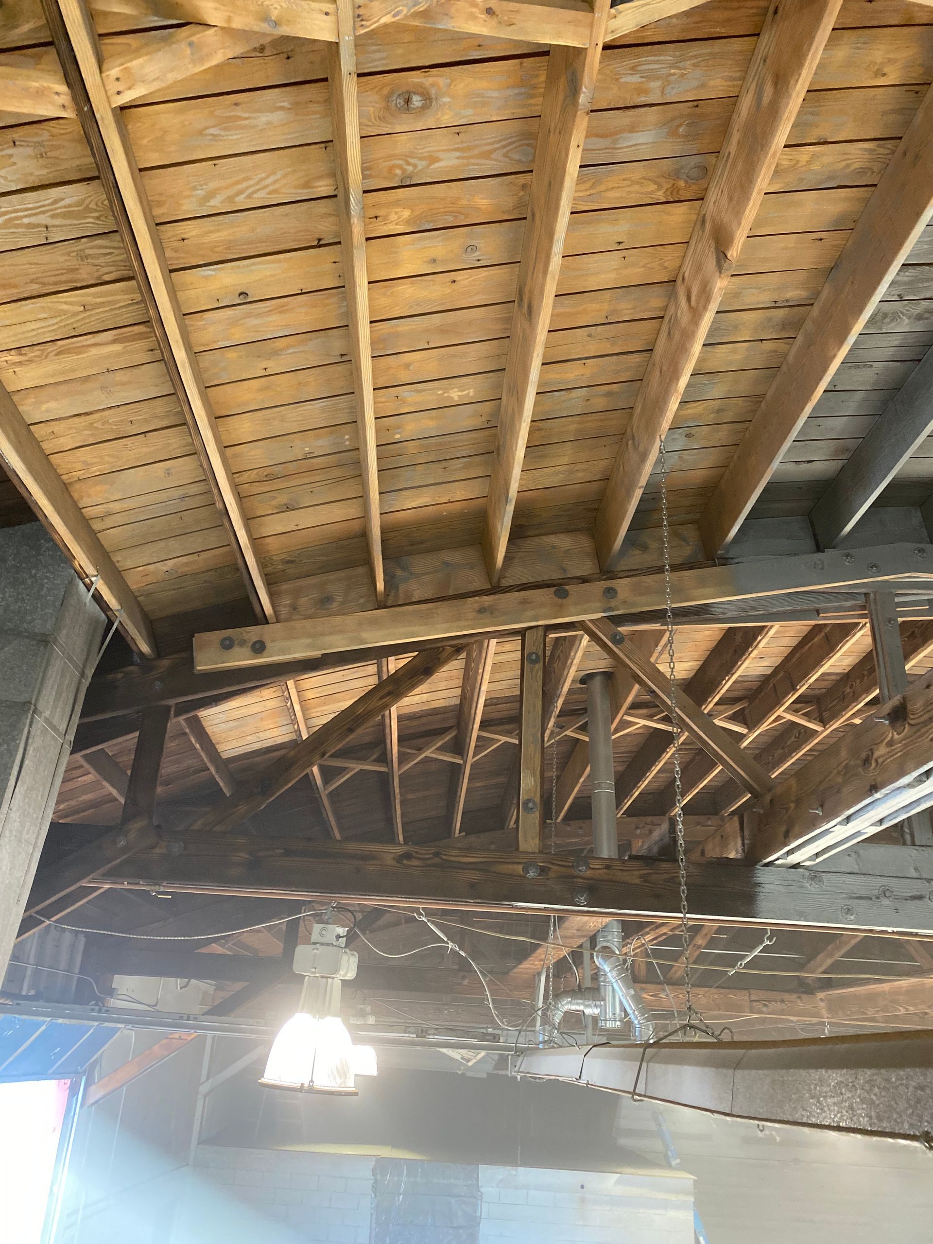 Wood ceiling construction with beams and exposed rafters.