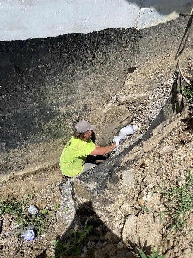 Man in green shirt working