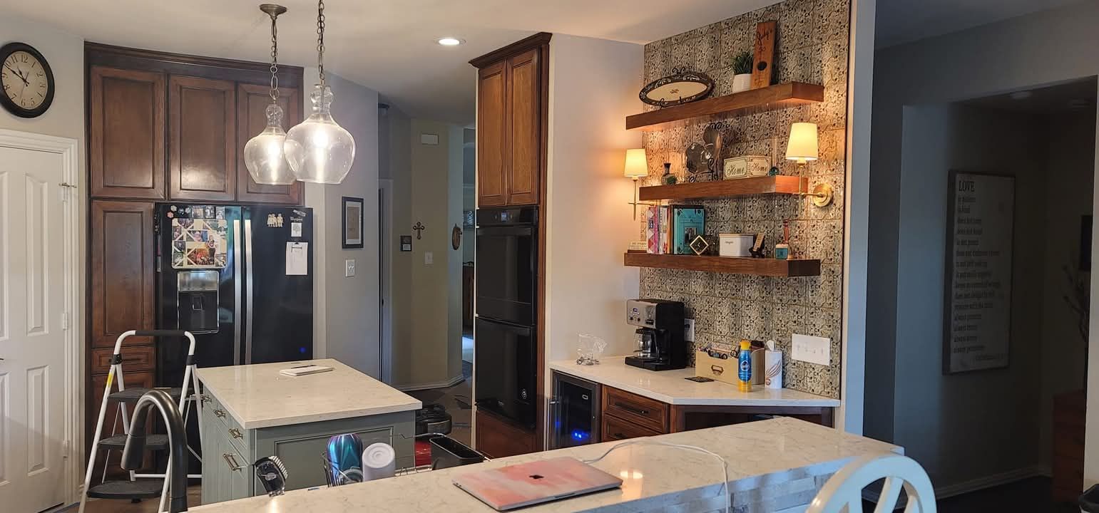 A kitchen with a large island and a clock on the wall