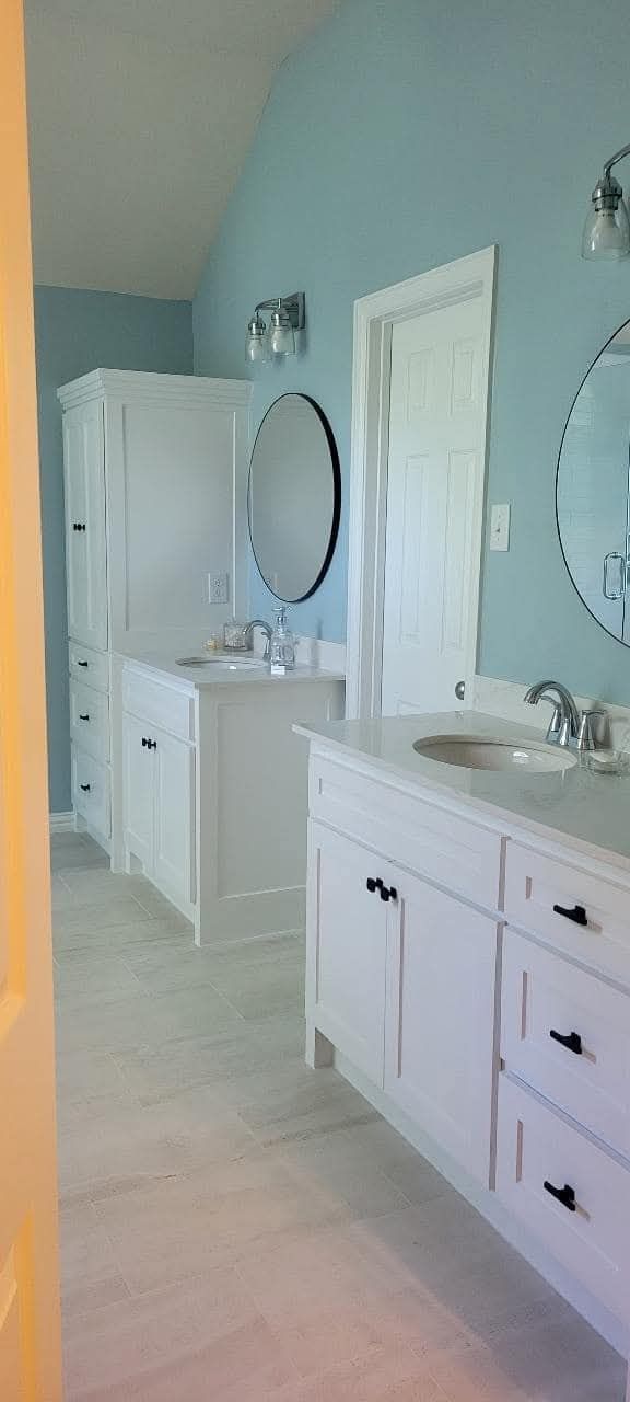 A bathroom with two sinks and two mirrors