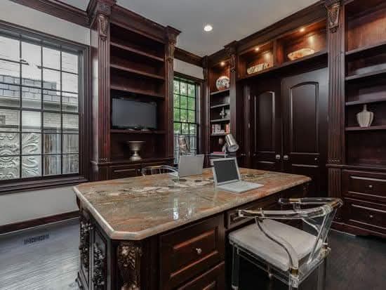 A home office with a desk and chair and a laptop on it