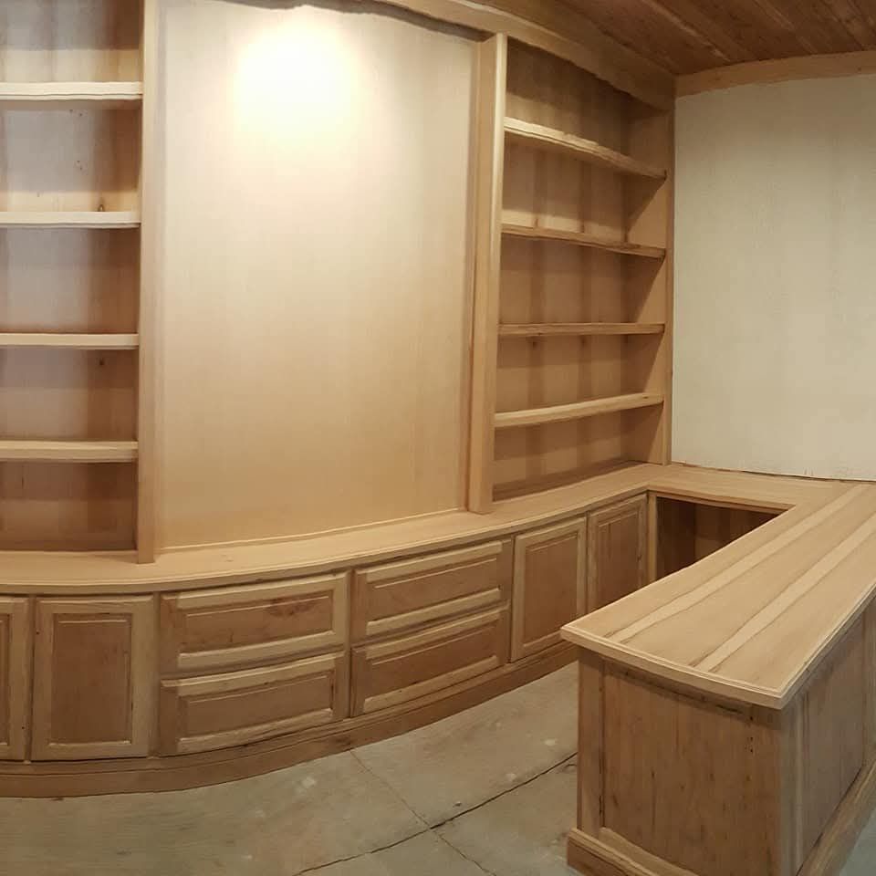 A room with lots of wooden cabinets and shelves