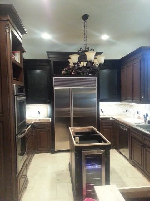 A kitchen with stainless steel appliances and wooden cabinets