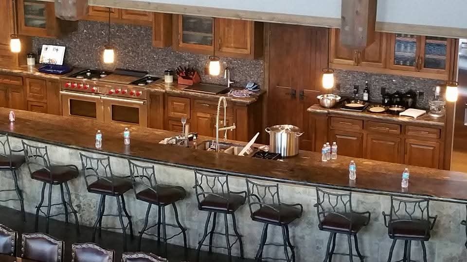 A kitchen with a long counter and stool