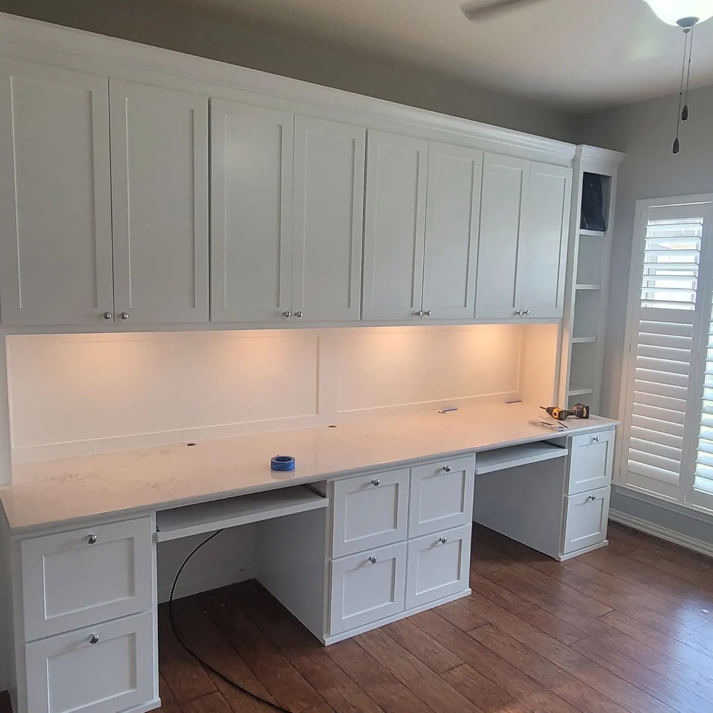 There is a large desk in the middle of the room