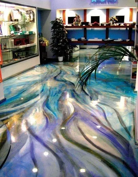 Glossy blue, white, and purple swirled floor in a modern lobby with a reception desk and display cases