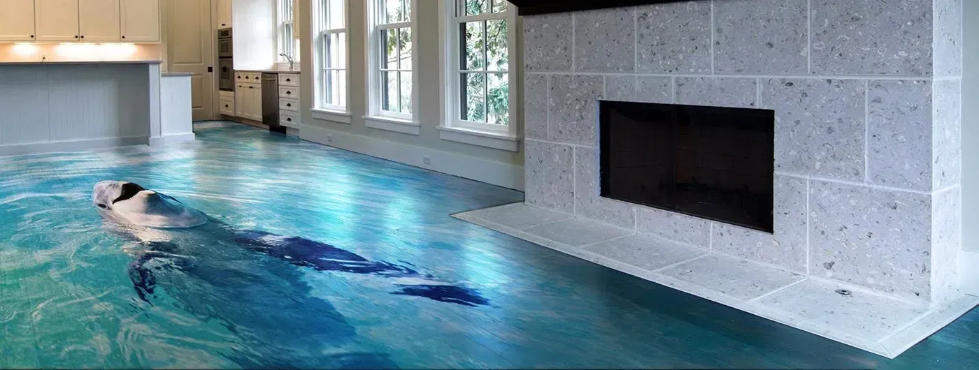 Indoor lap pool with a swimmer and a stone fireplace beside the water