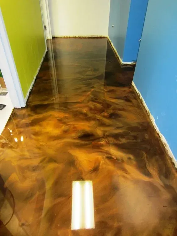 Glossy brown marbled floor in a narrow hallway with blue and green walls