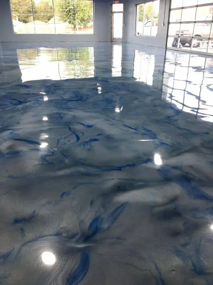 Glossy blue-and-white marbled floor in a bright room with sunlit reflections