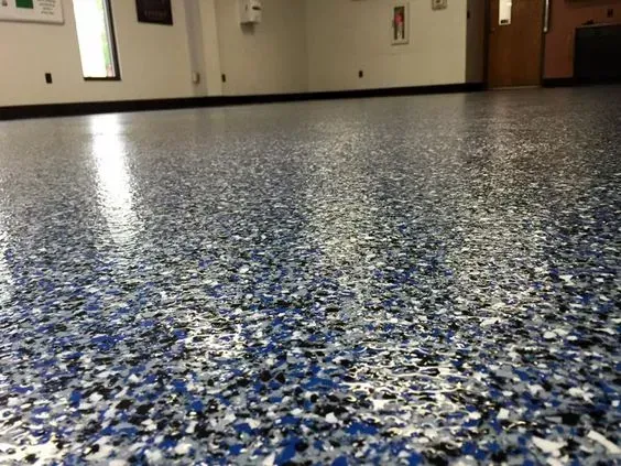 Blue-and-gray speckled floor in a quiet indoor hallway