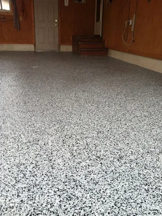 Empty carpeted room with wood-paneled walls and a small set of steps at the back.