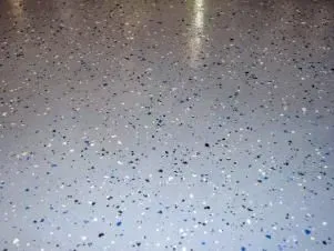 Speckled gray terrazzo floor with small black, white, and blue flecks