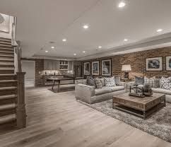 Spacious modern living room with gray sofa, coffee table, fireplace, and recessed lighting