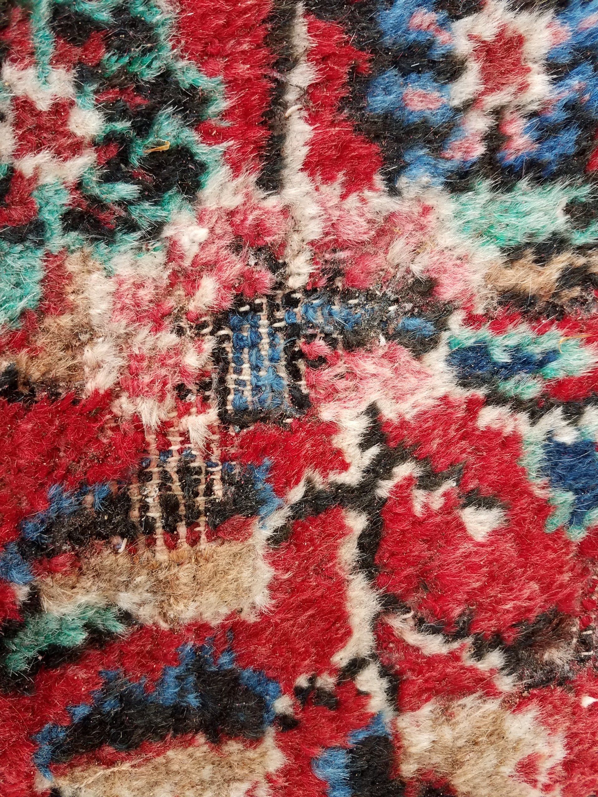 A close up of a colorful rug with a floral pattern
