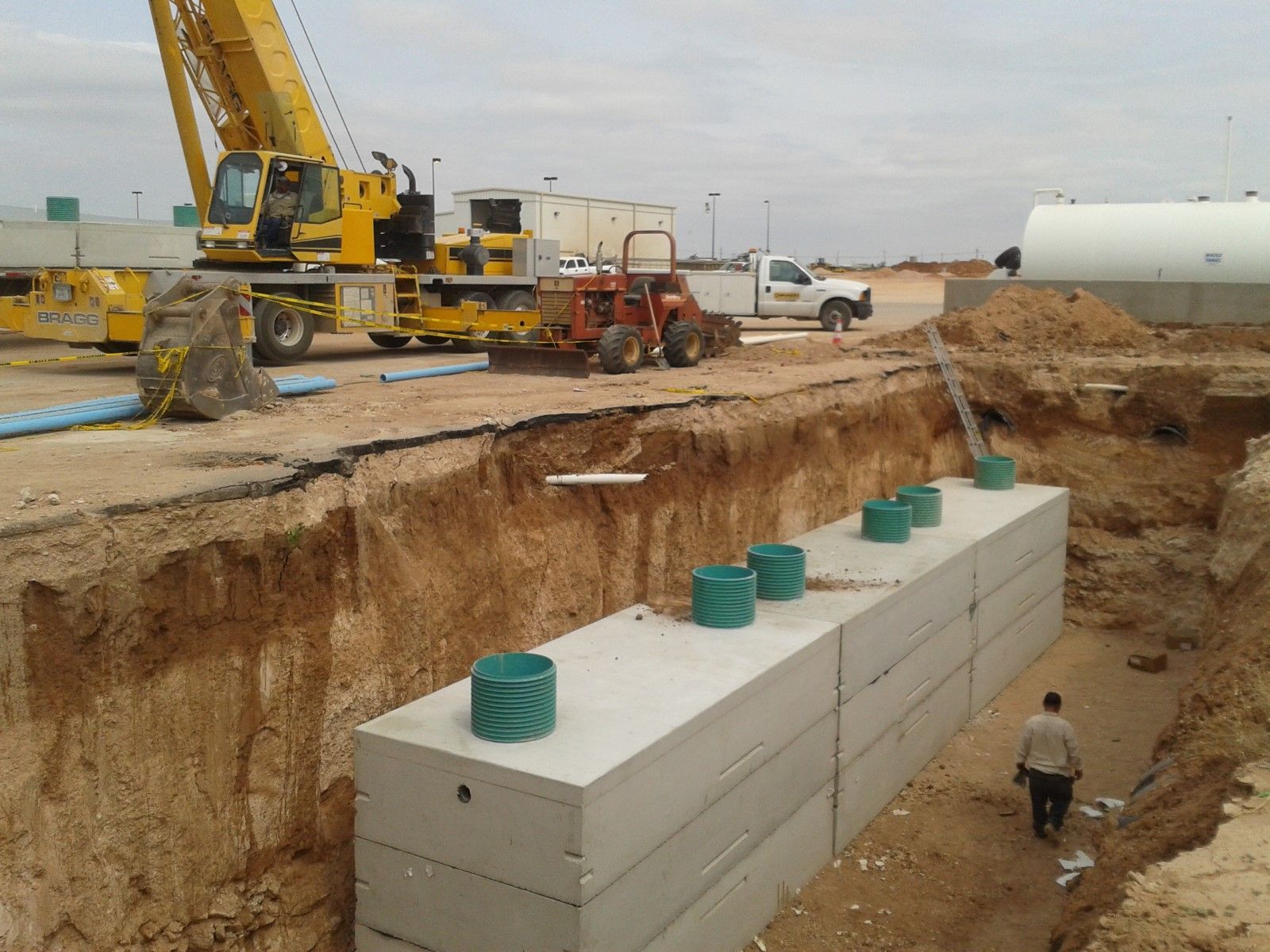 A construction site with a yellow crane in the background