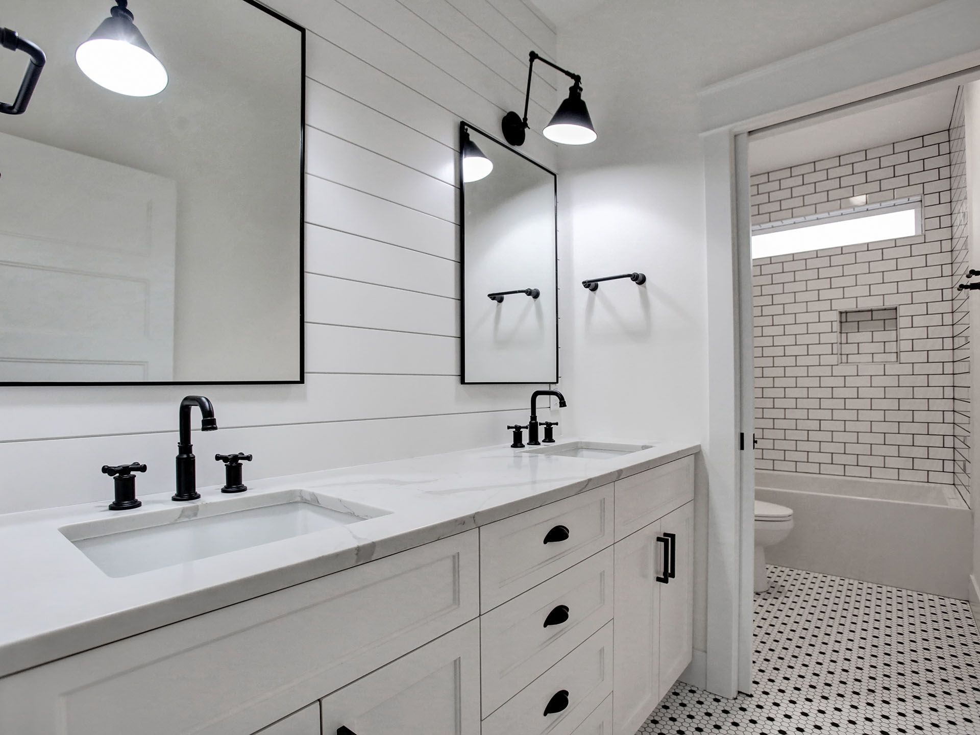 A bathroom with two sinks and two mirrors