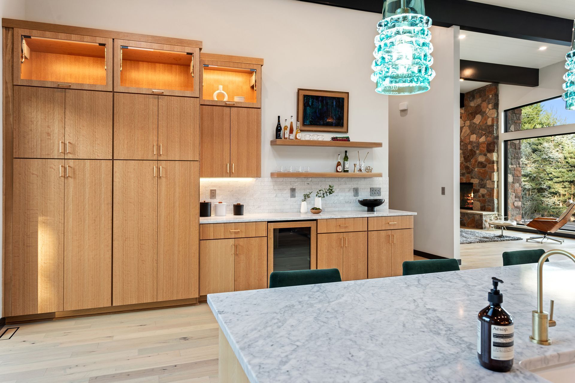 A kitchen with wooden cabinets and a marble counter top
