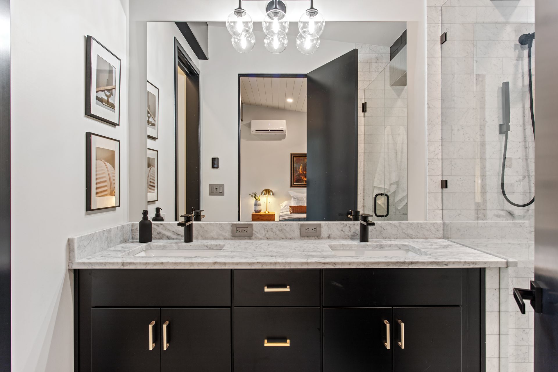 A bathroom with two sinks and a large mirror.