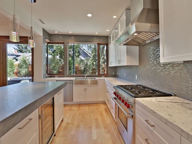 A kitchen with white cabinets and stainless steel appliances