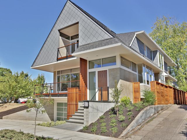 A house with a lot of windows and trees in the background