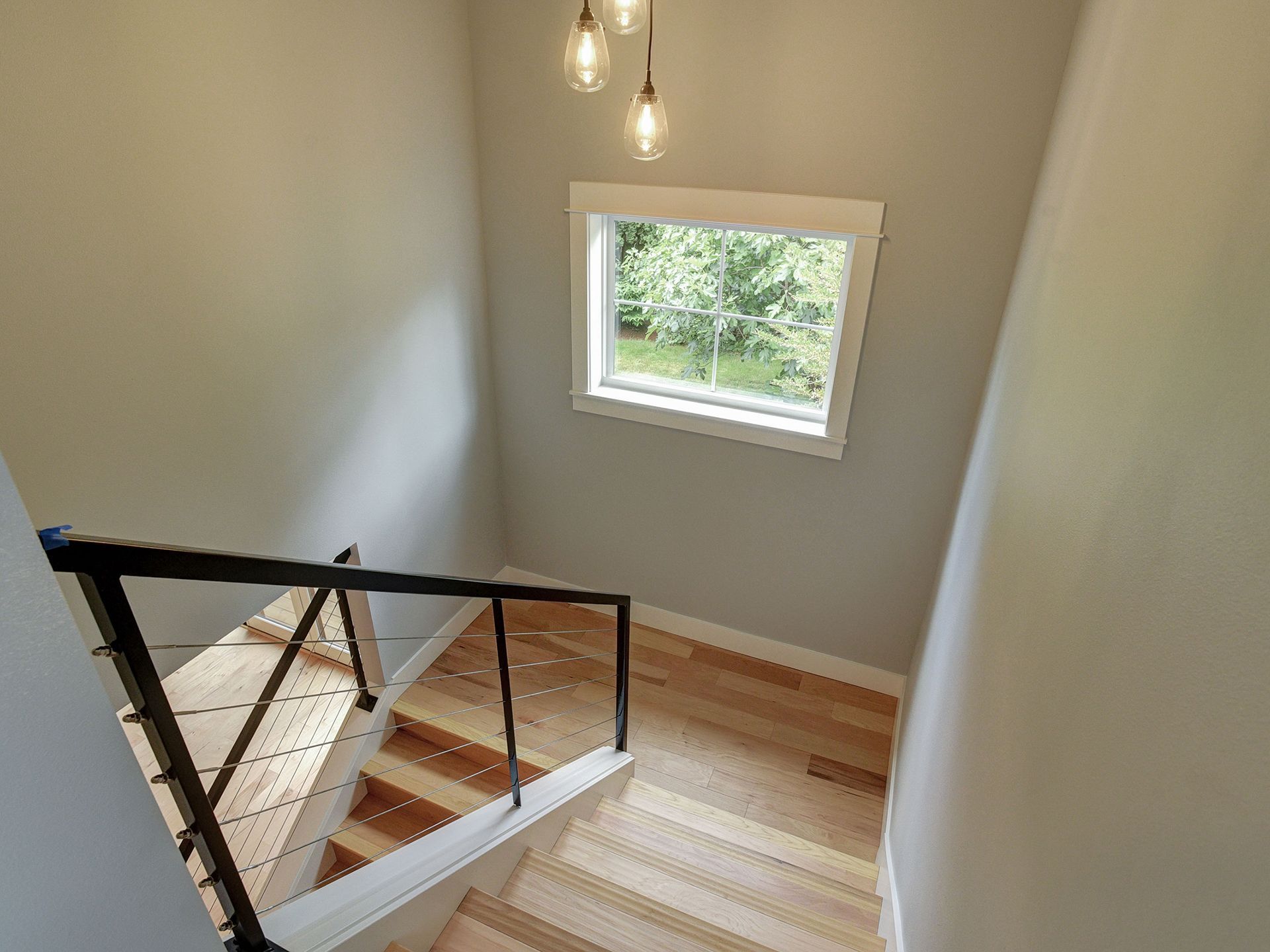 A staircase with wooden steps and a window on the wall