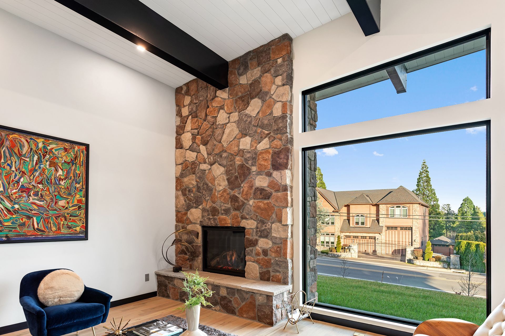 A living room with a fireplace and a large window