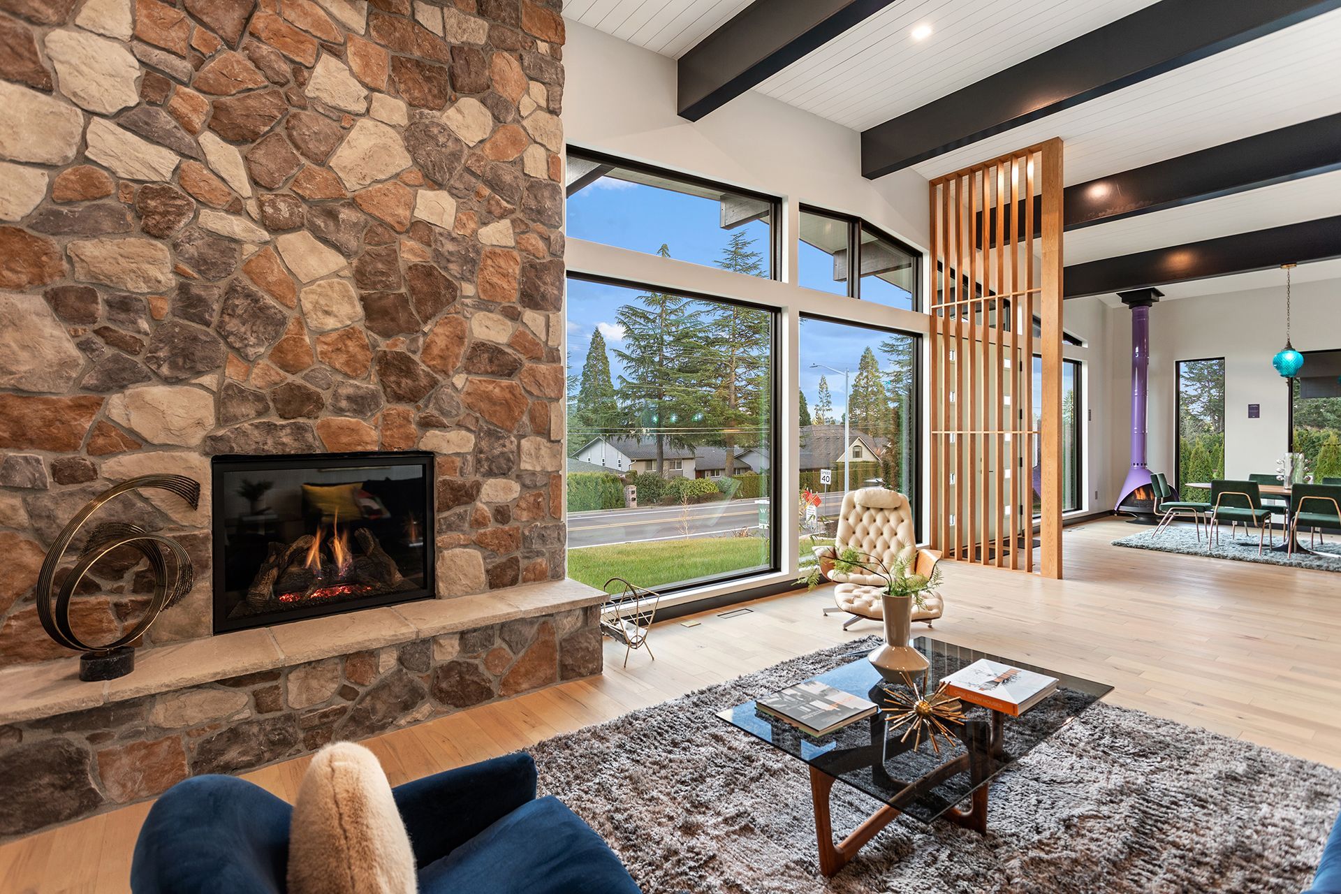 A living room with a stone fireplace 
