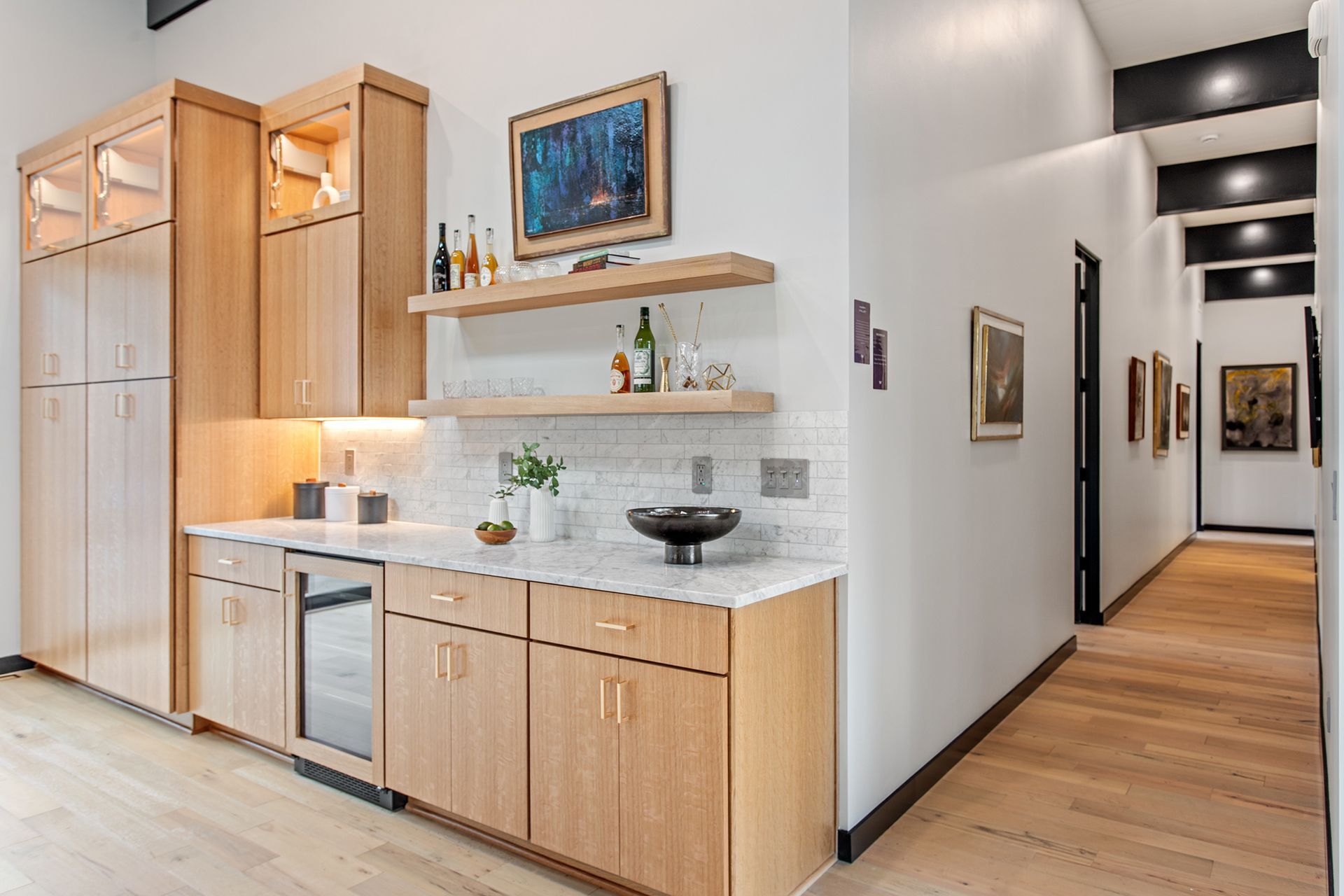 A kitchen with wooden cabinets and white walls