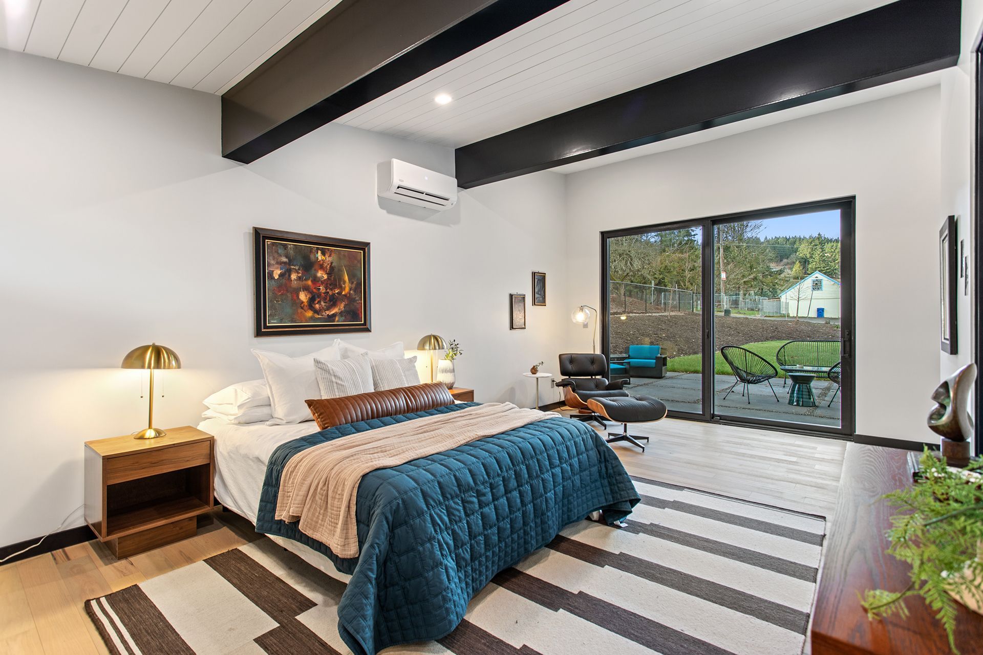 Minimalist bedroom with large bed and white walls