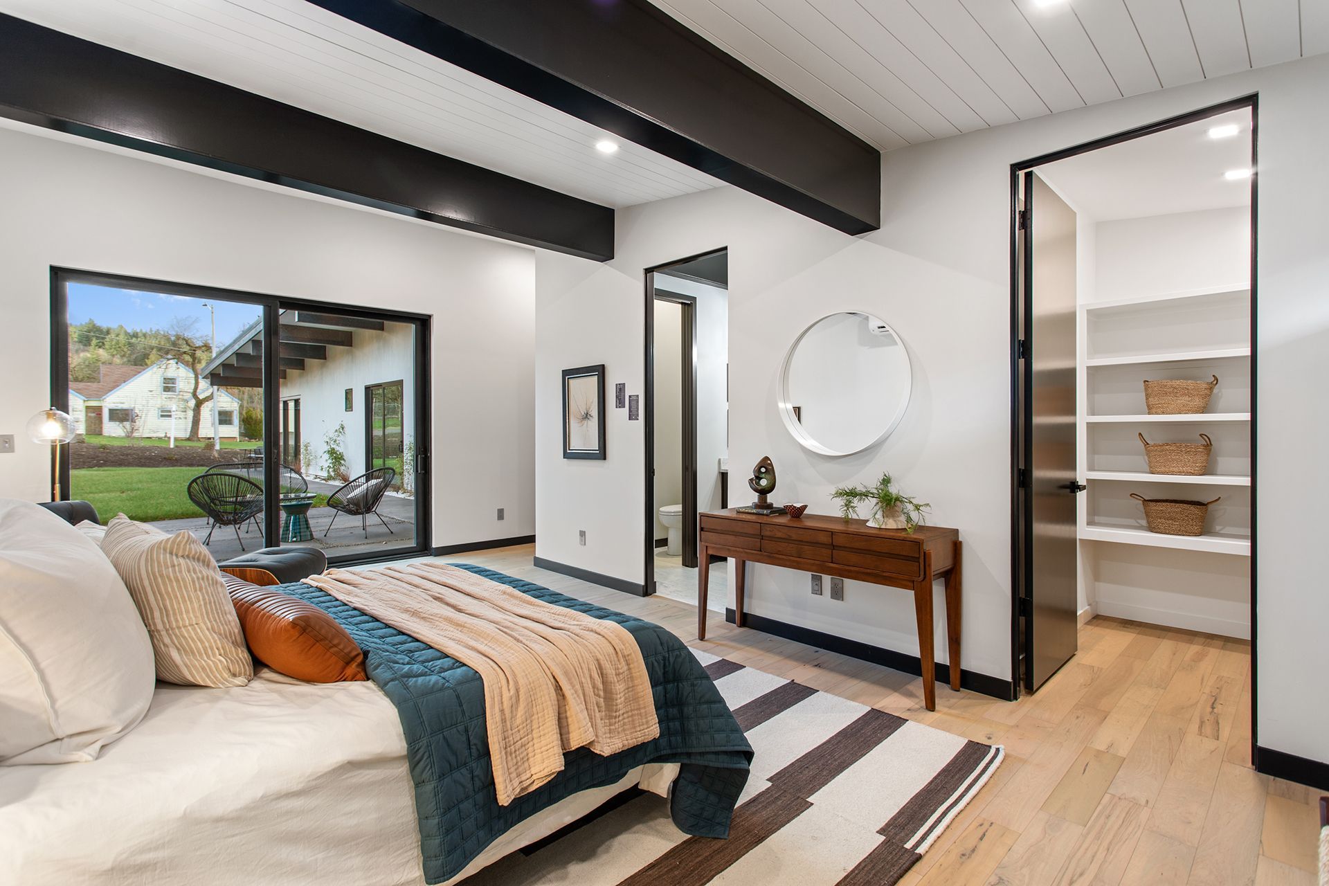 A bedroom with a door leading to a walk-in closet
