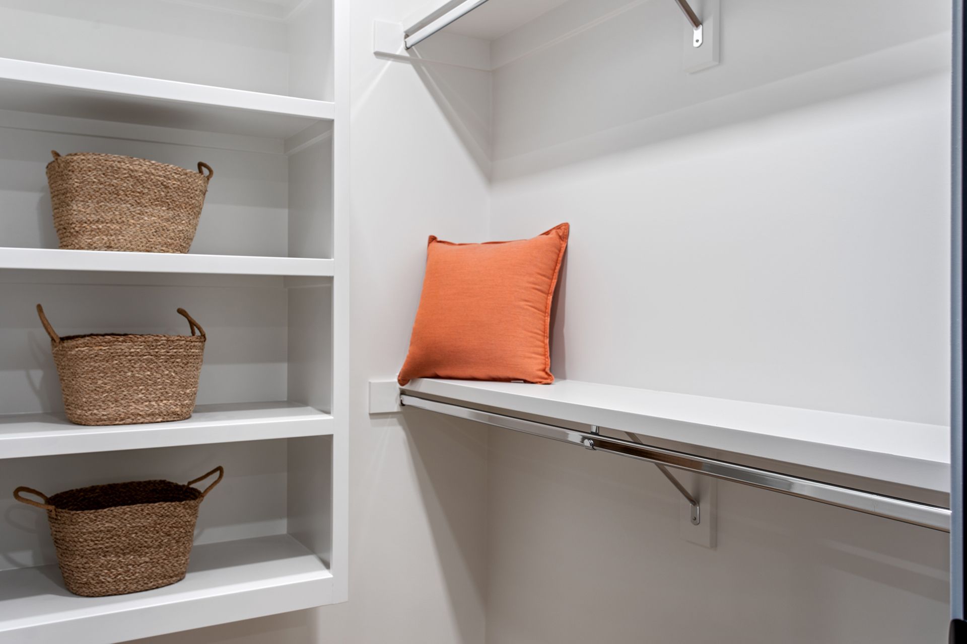 Walk-in closet with white walls