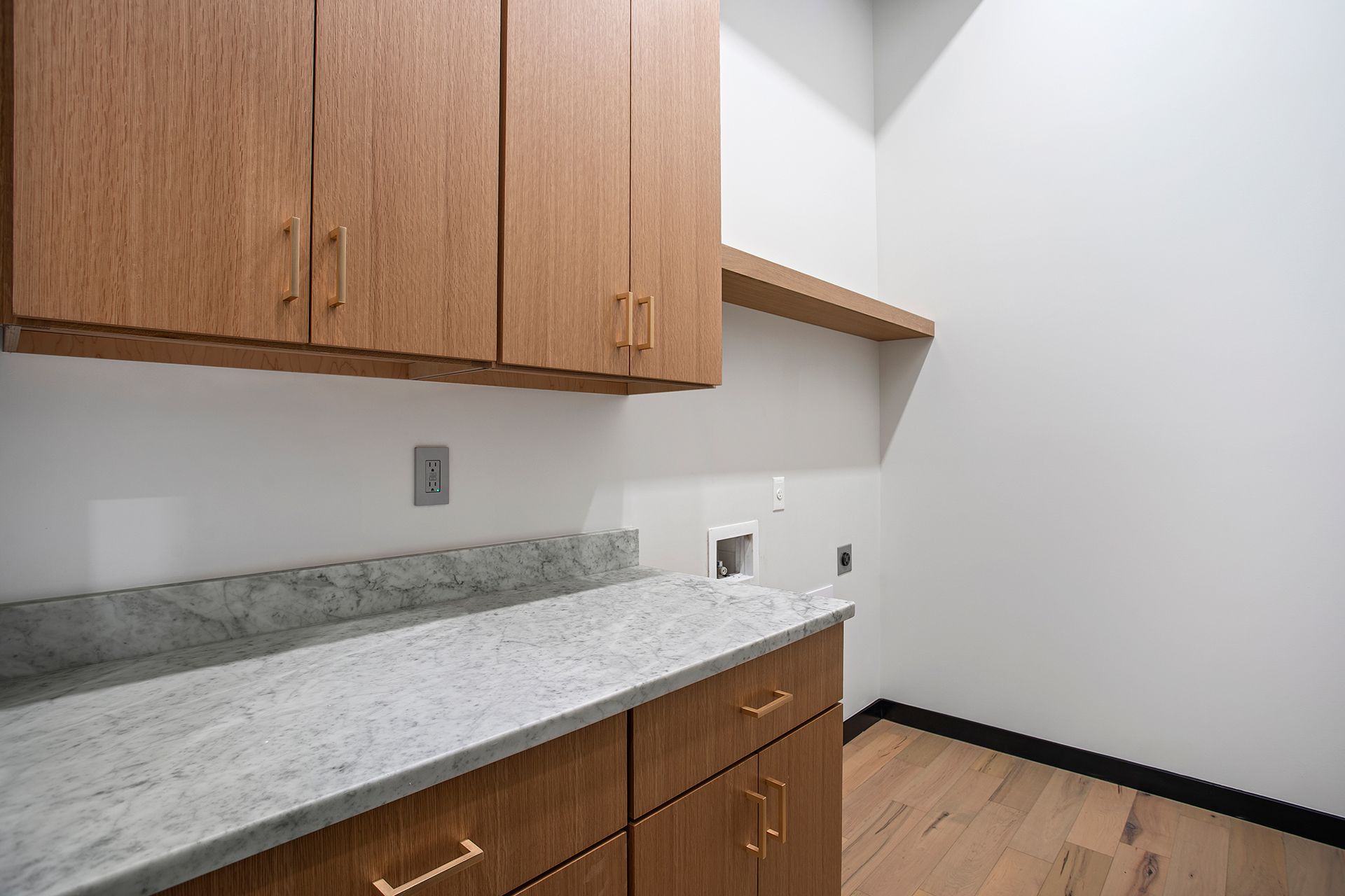 Room with a granite counter top and wood cabinets