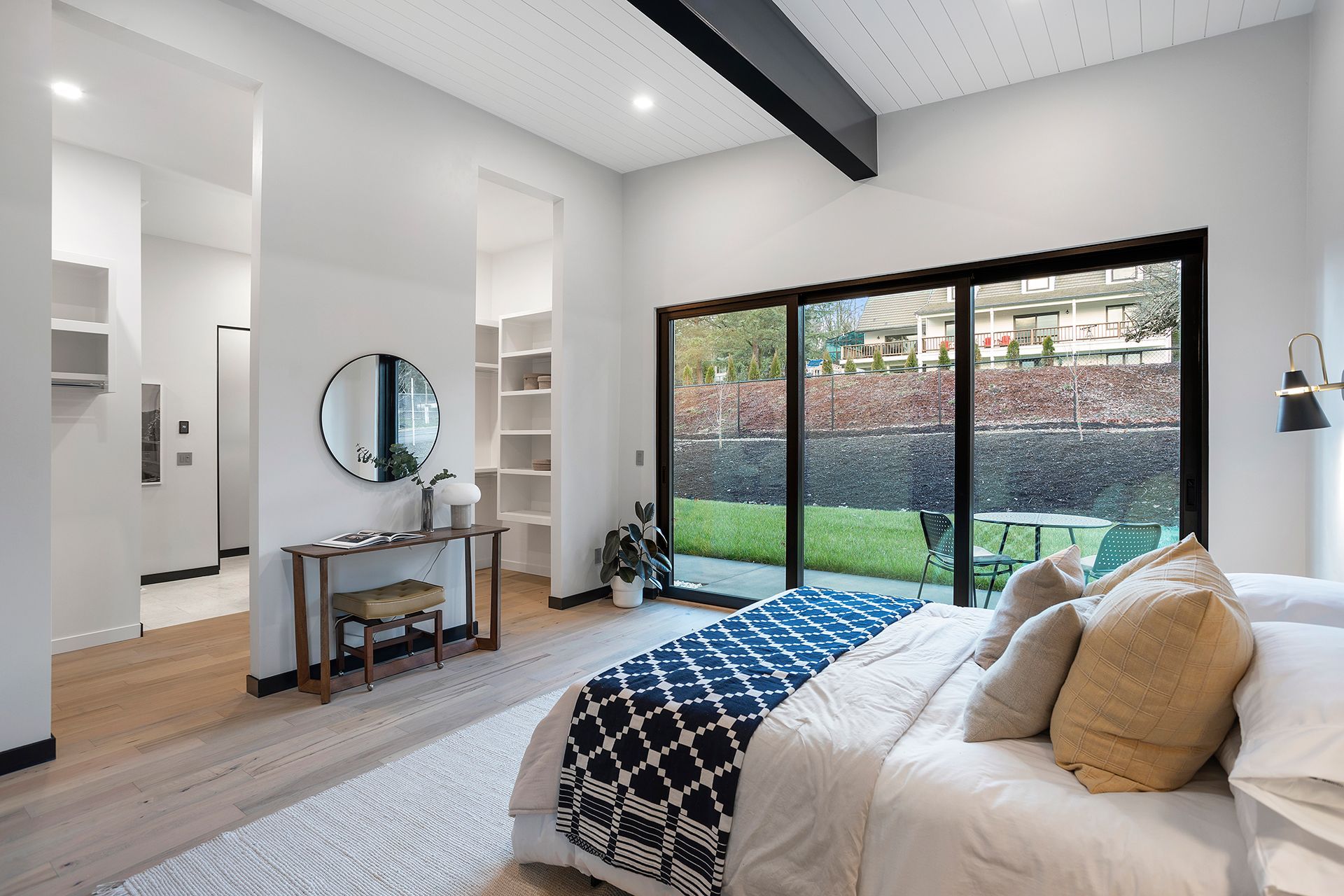 A bedroom facing a wall with a mirror