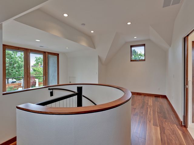 An empty room with a spiral staircase and a window