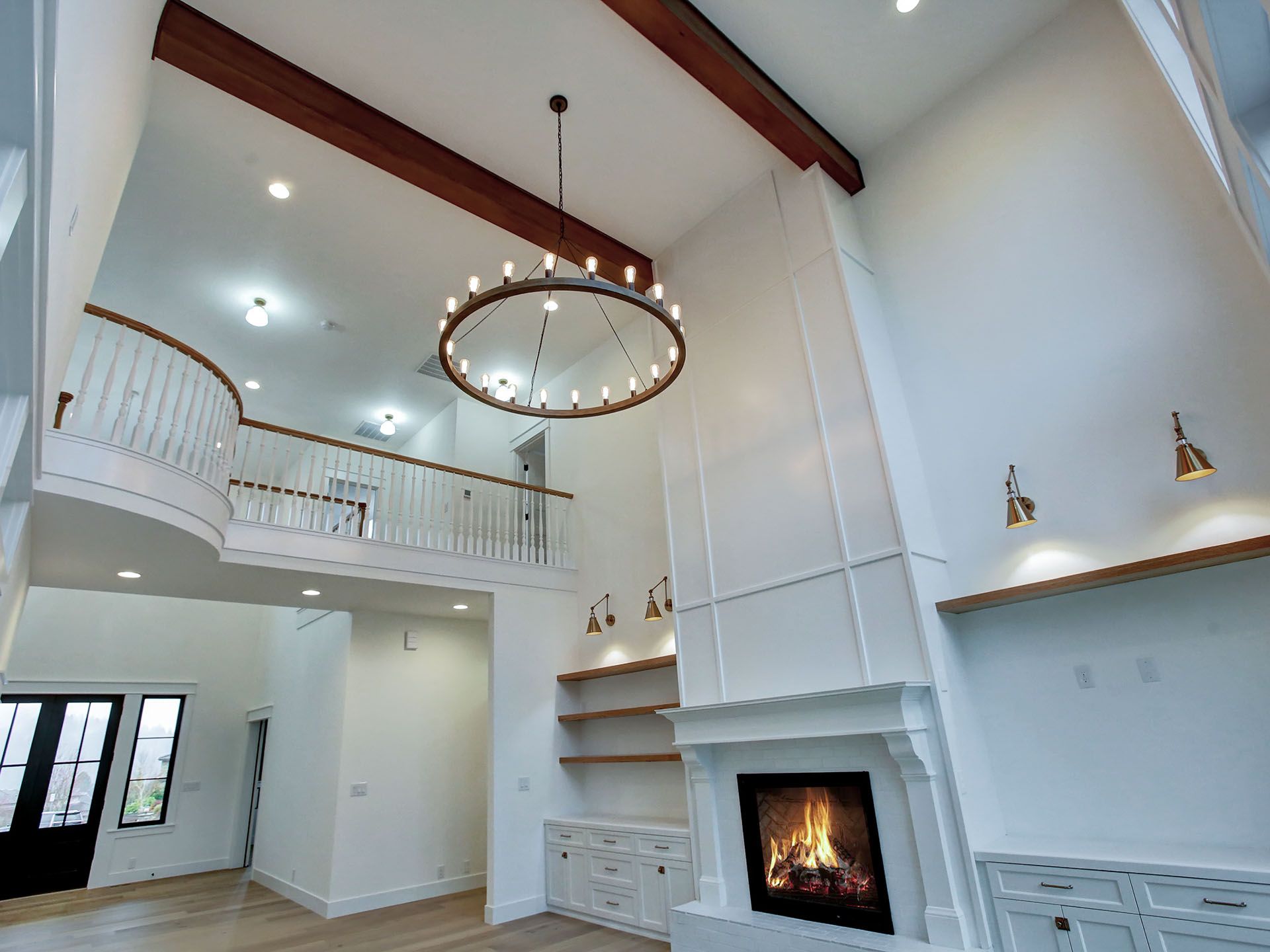 A living room with a chandelier hanging from the ceiling