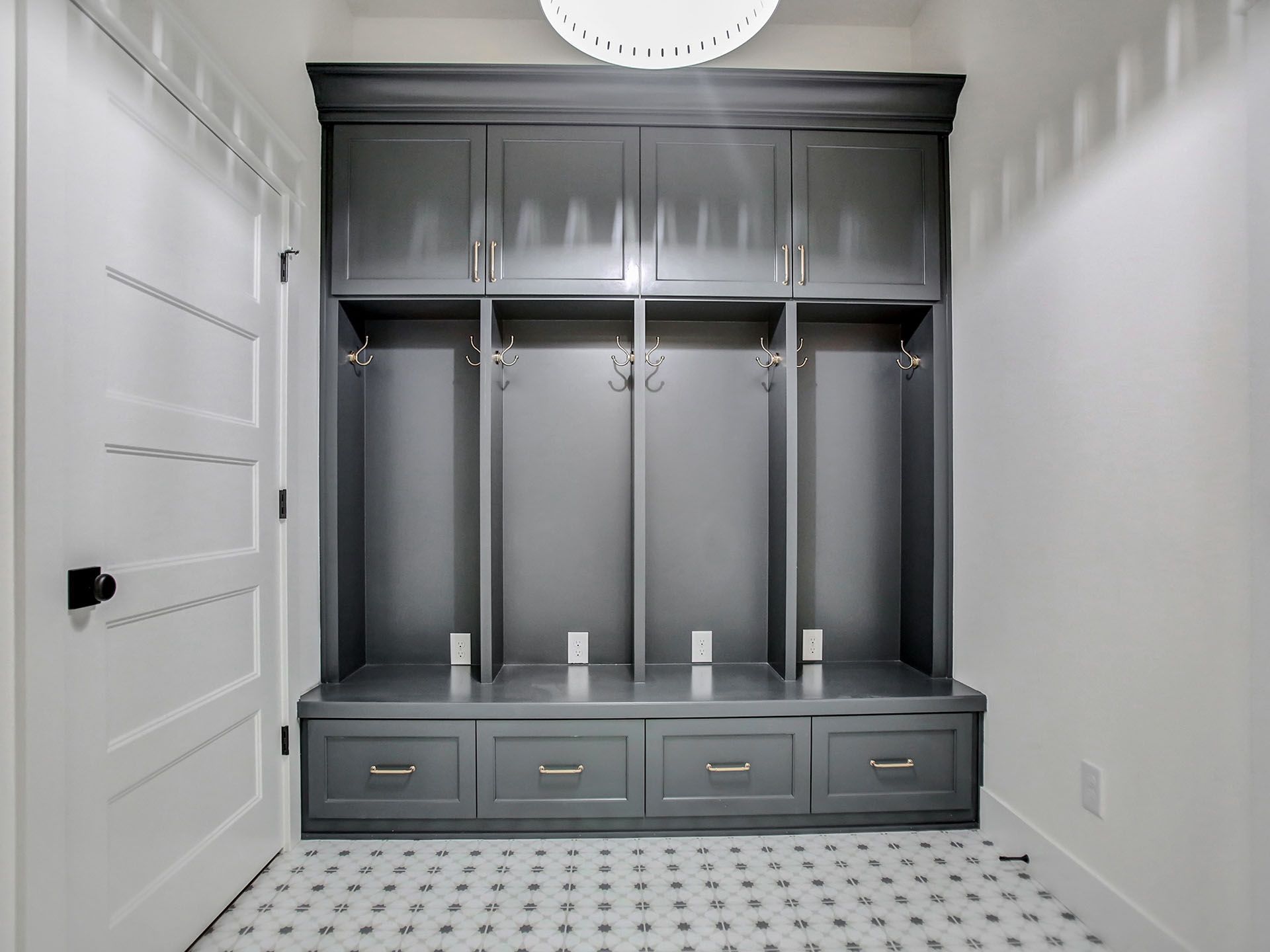A mud room with gray cabinets and drawers 
