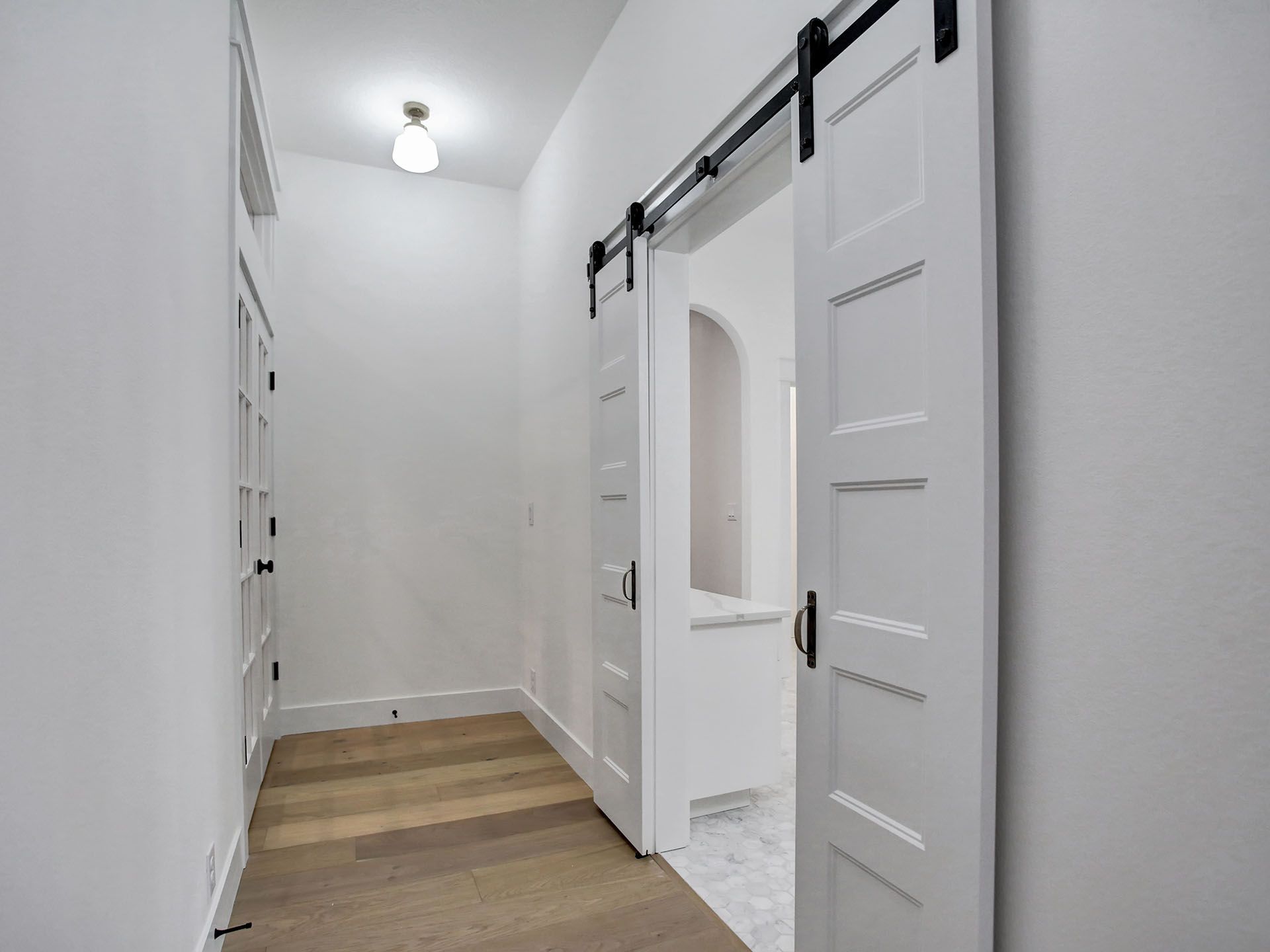 A hallway with sliding barn doors