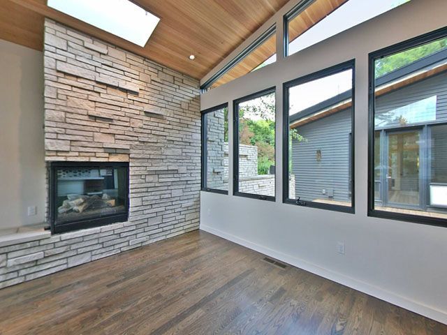 A living room with a stone fireplace