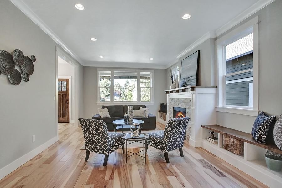 A living room with hardwood floors and cool-looking chairs