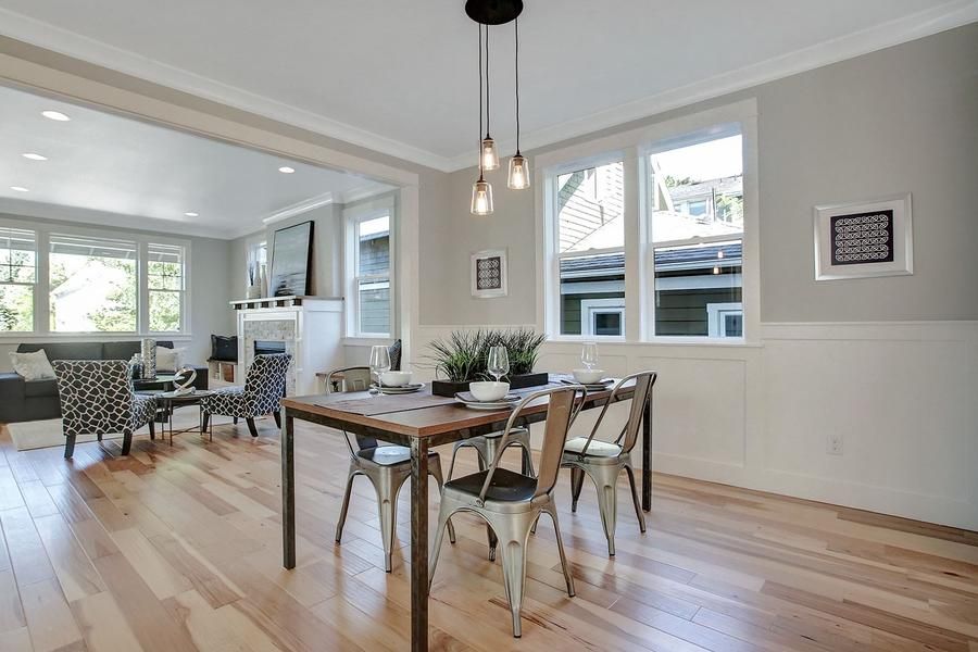 A dining room with a wooden table and chairs