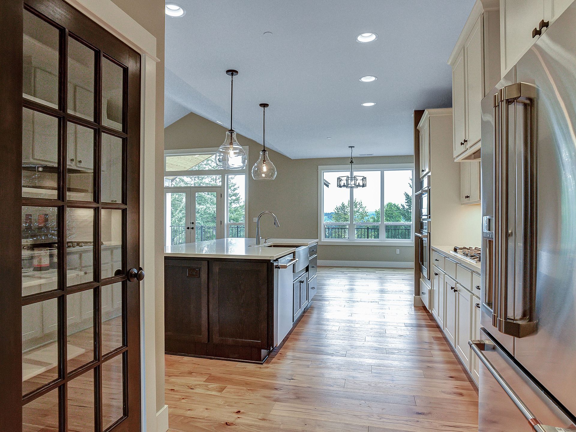A kitchen with a large island and stainless steel appliances