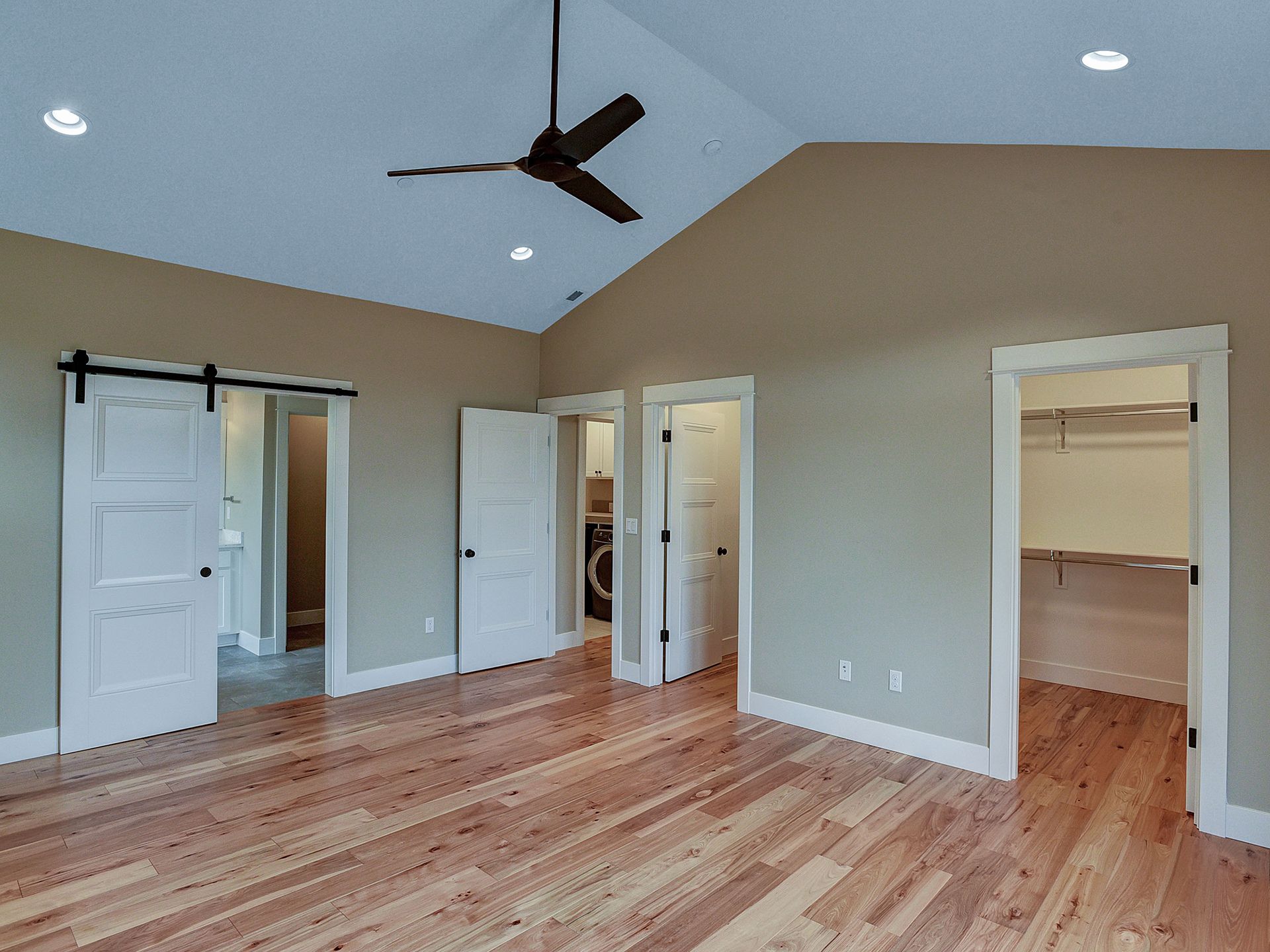 An empty bedroom with four open doors