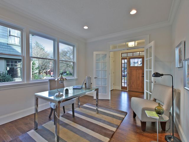 A home office with a desk, chair, and rug