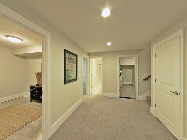 A hallway in a house with a picture on the wall