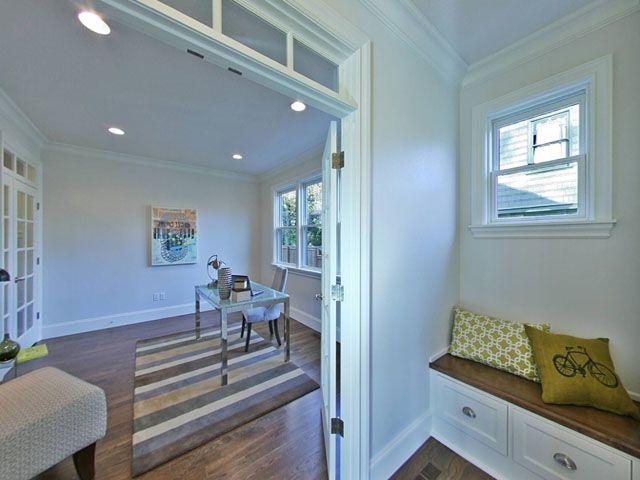 A room with a desk and a bench 